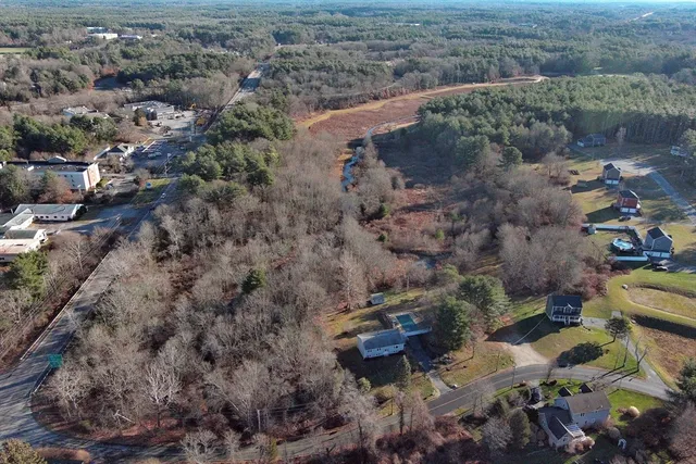 an aerial view of a house with a yard