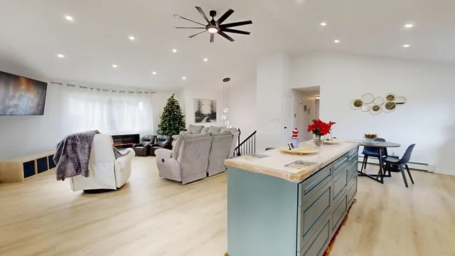 a living room with furniture and kitchen view