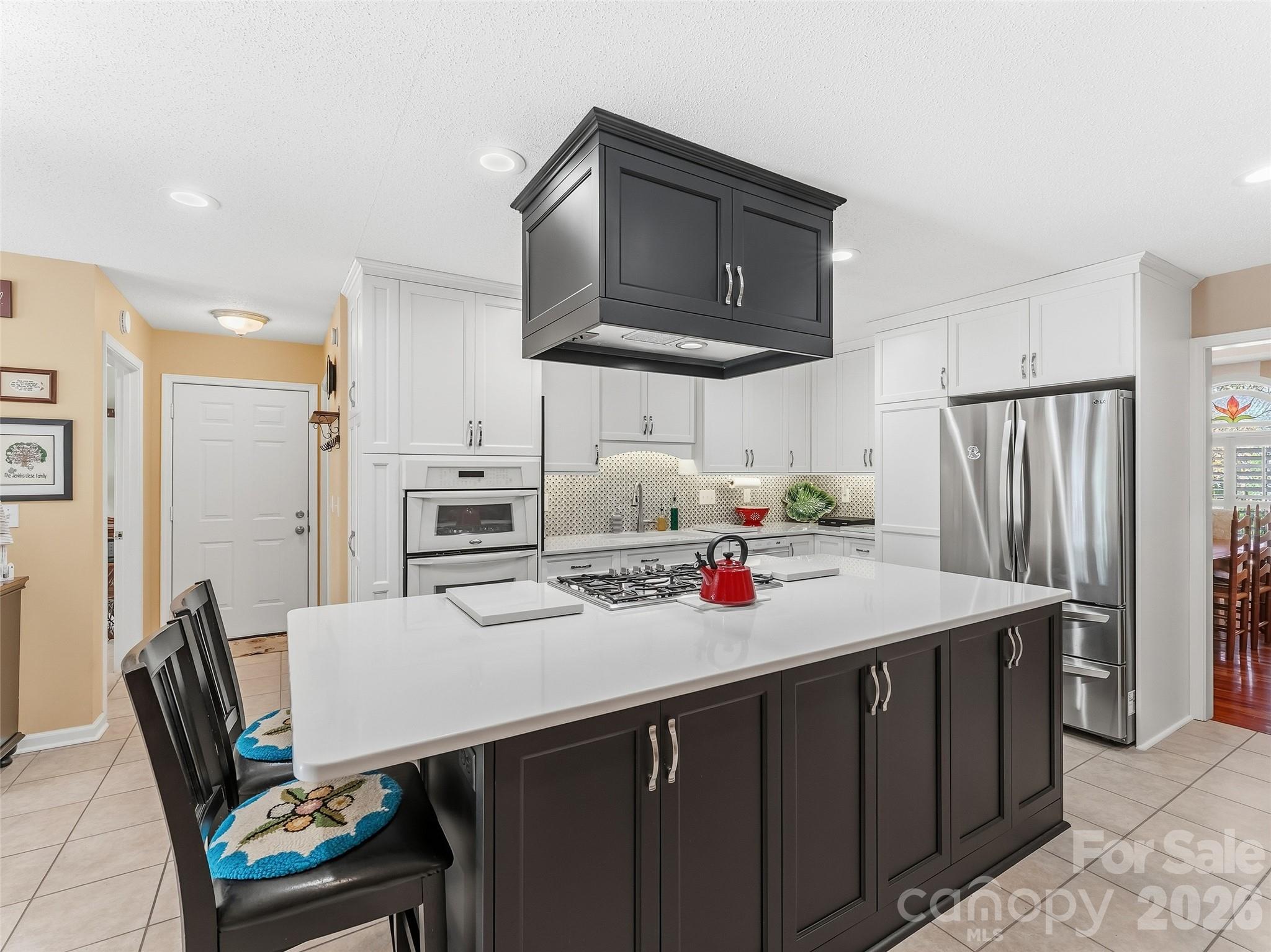1340 Macedonia Road Saluda, NC 28773 - Photo 14 of 45 a kitchen with stainless steel appliances a stove a sink dishwasher and a refrigerator with wooden cabinets