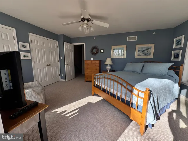 a bedroom with a bed and glass door