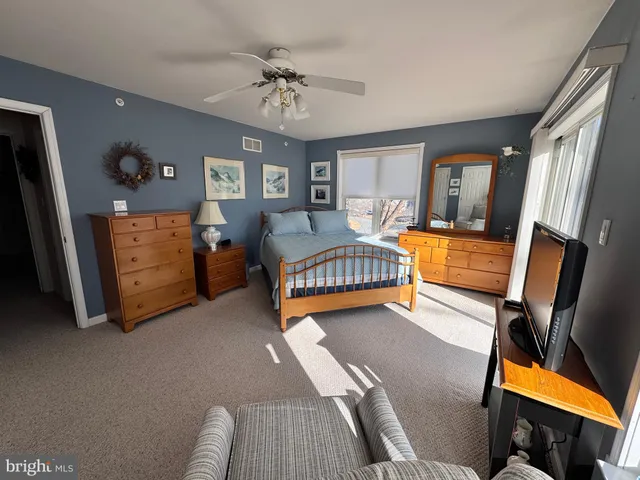 a bathroom with a sink double vanity granite tub shower and a mirror