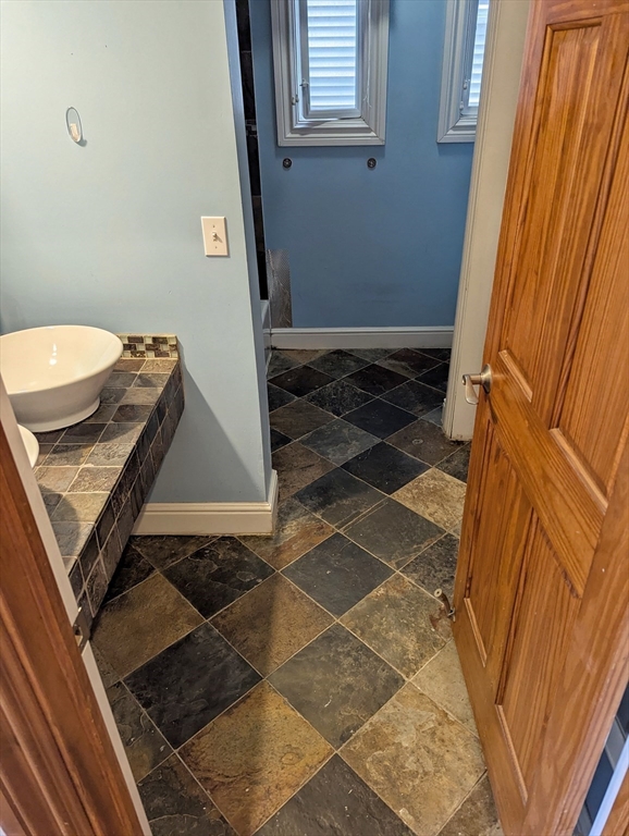 176 Hillside Street, Unit 101 Boston, MA 02120 - Photo 7 of 16 a bathroom with a sink and a mirror