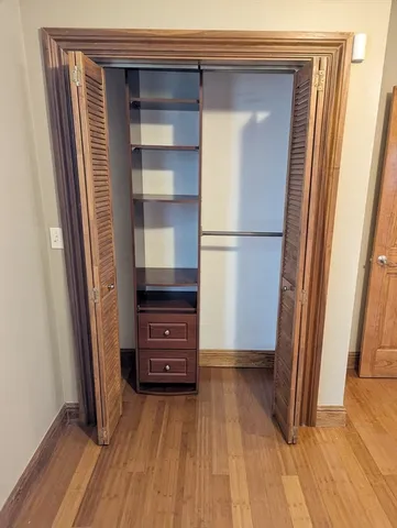 a view of walk in closet with empty racks