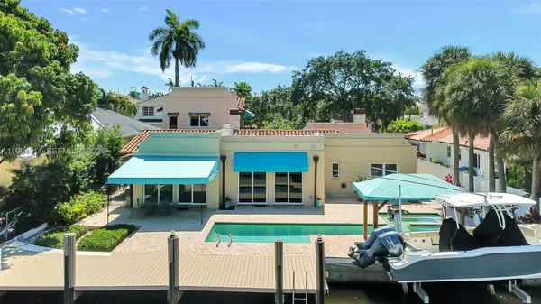 a view of a table and chairs under an umbrella