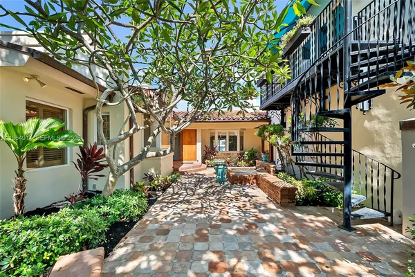 a row of palm trees in front of house