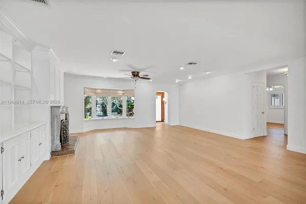 wooden floor in an empty room with a window