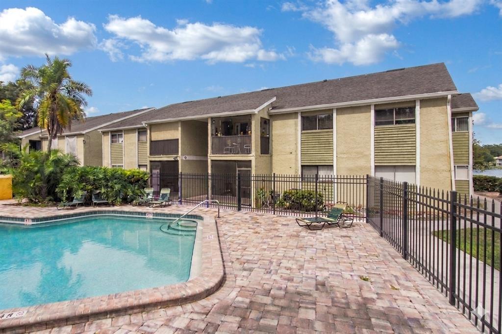 912 Lake Destiny Road, Unit F Altamonte Springs, FL 32714 - Photo 1 of 12 a view of a house with swimming pool and porch