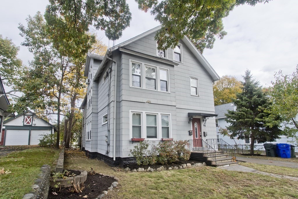 a front view of a house with garden