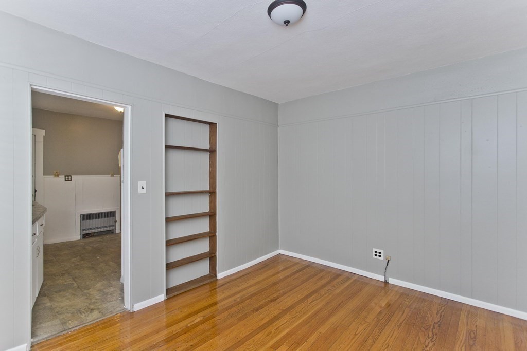 69 Appleton Street Springfield, MA 01108 - Photo 11 of 34 an empty room with wooden floor closet and windows