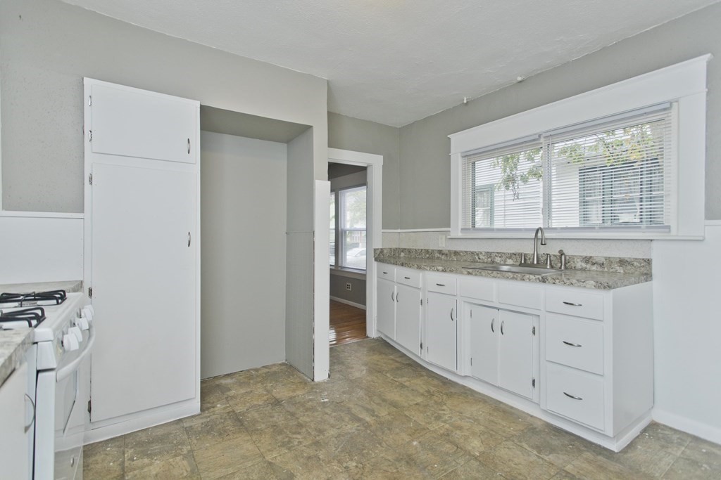 69 Appleton Street Springfield, MA 01108 - Photo 13 of 34 a bathroom with granite countertop a sink and a window