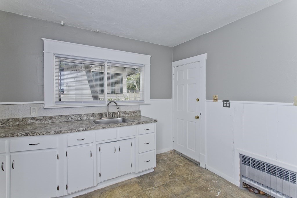 69 Appleton Street Springfield, MA 01108 - Photo 15 of 34 a bathroom with a granite countertop sink and a window