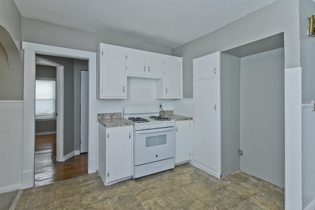 69 Appleton Street Springfield, MA 01108 - Photo 16 of 34 a kitchen with a stove sink and cabinets