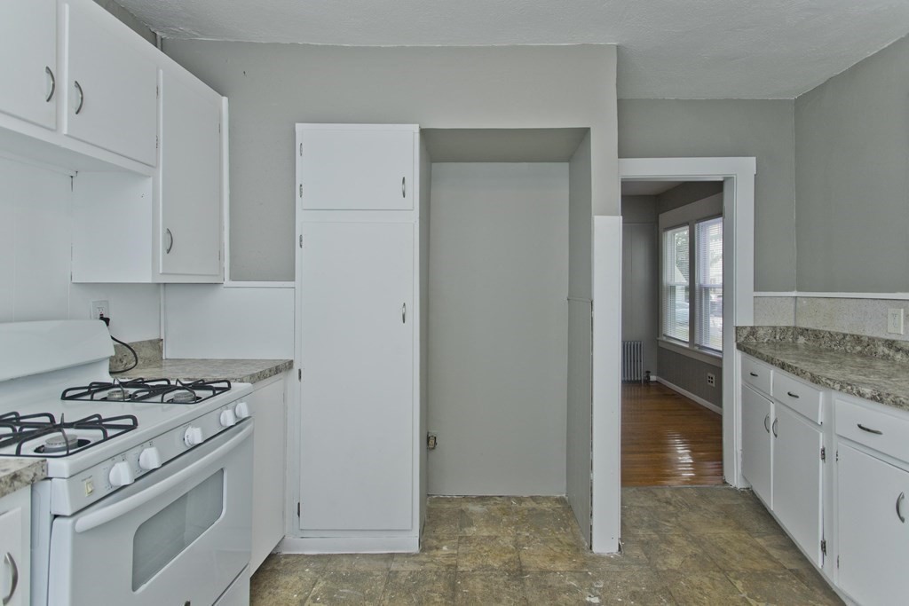 69 Appleton Street Springfield, MA 01108 - Photo 17 of 34 a kitchen with granite countertop a stove and a sink