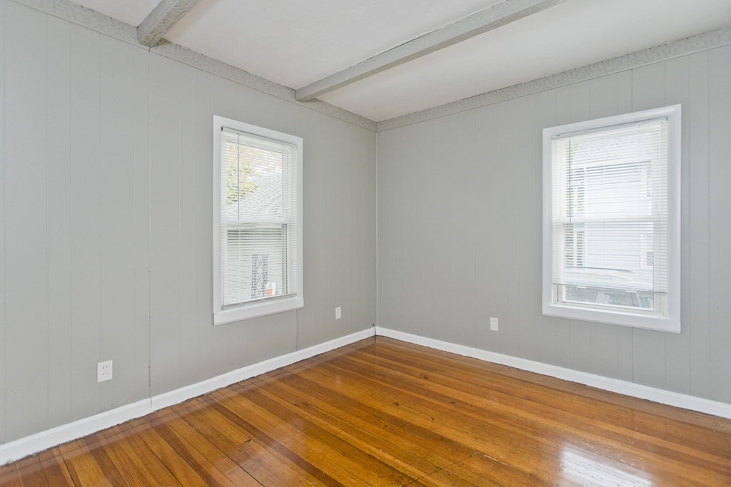 69 Appleton Street Springfield, MA 01108 - Photo 21 of 34 an empty room with wooden floor and windows