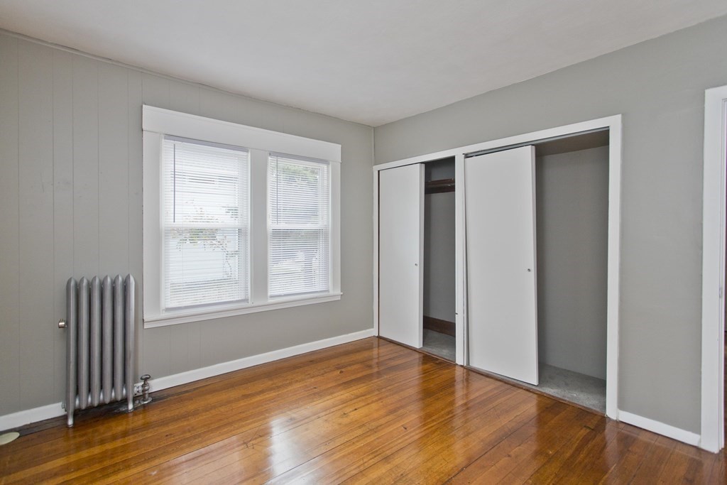 69 Appleton Street Springfield, MA 01108 - Photo 26 of 34 an empty room with wooden floor and windows