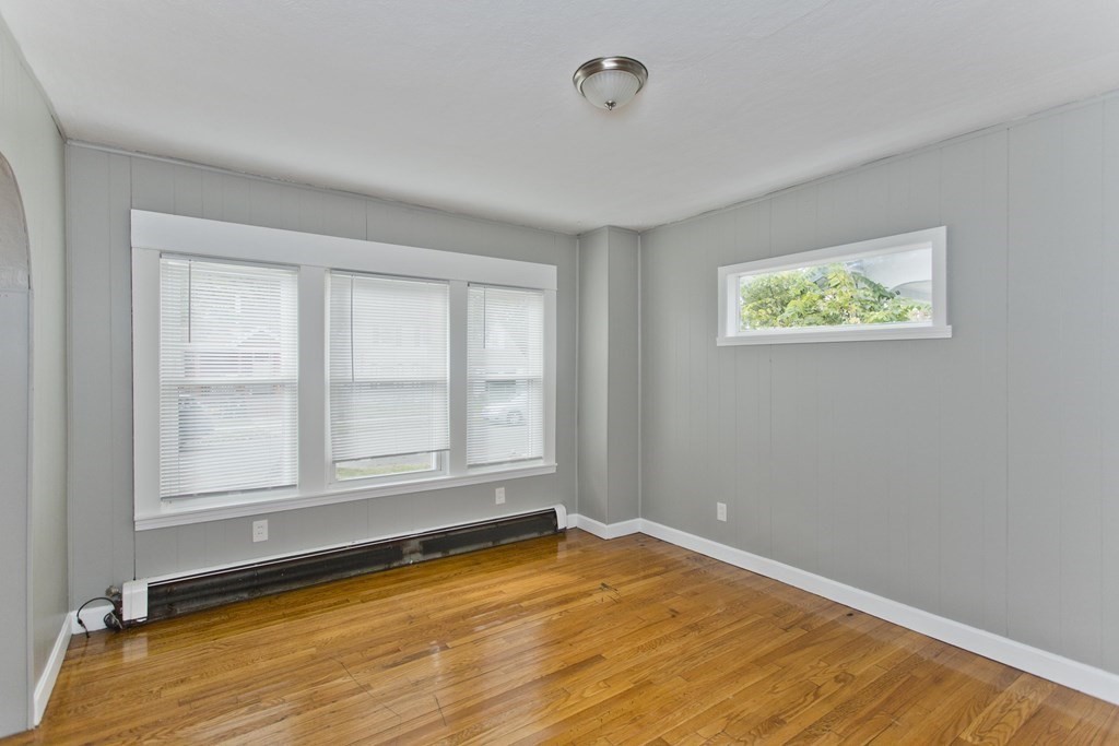 69 Appleton Street Springfield, MA 01108 - Photo 5 of 34 an empty room with wooden floor and windows