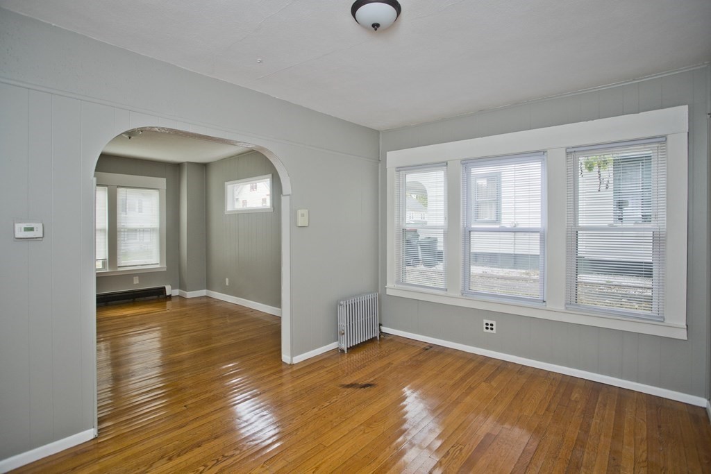 69 Appleton Street Springfield, MA 01108 - Photo 7 of 34 an empty room with wooden floor and windows
