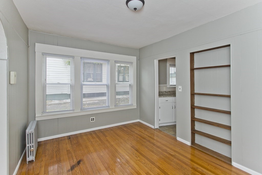 69 Appleton Street Springfield, MA 01108 - Photo 9 of 34 a view of an empty room with a window and wooden floor