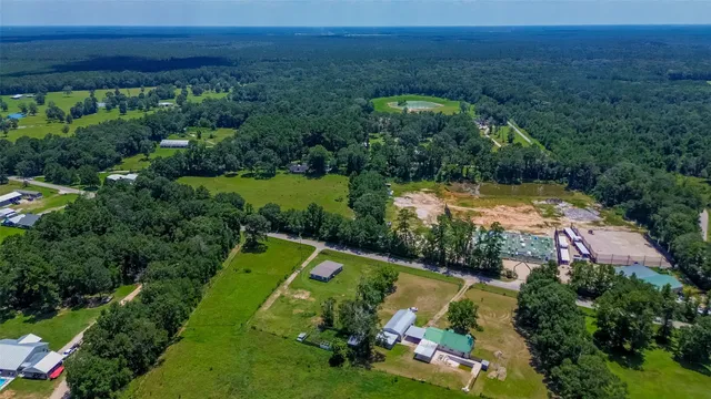 an aerial view of a house with a garden and lake view