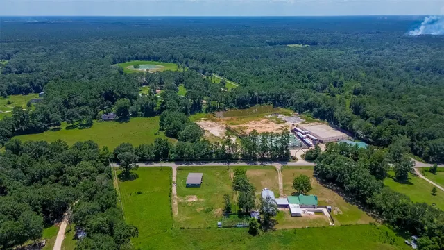 an aerial view of a house with yard swimming pool and outdoor seating