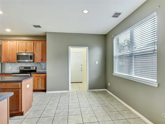 a view of a kitchen with a stove cabinets and a kitchen