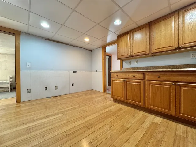 a view of a kitchen with stainless steel appliances granite countertop a sink and cabinets