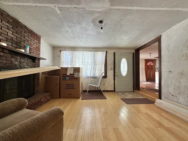 a living room with a couch and a dresser next to a window