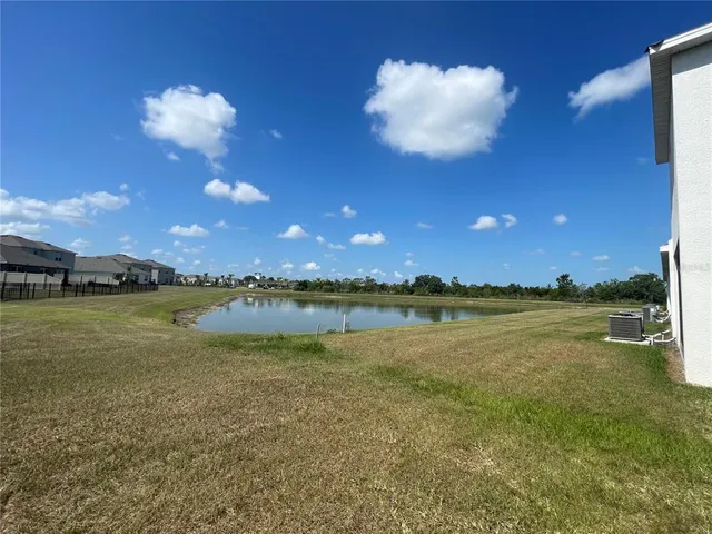 a view of a house with yard and porch