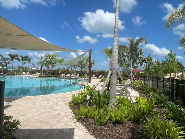 a front view of a house with a yard and outdoor seating