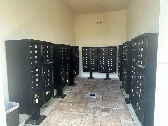 a view of a house with a big yard potted plants and a fountain