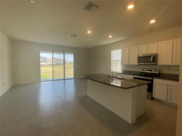 a kitchen with stainless steel appliances granite countertop a stove and a sink