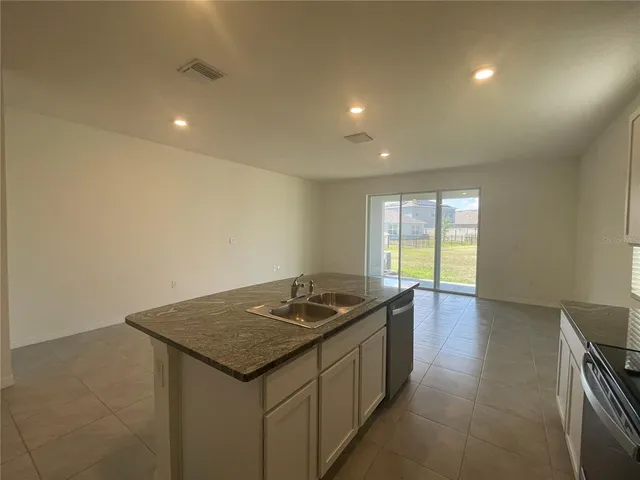 a kitchen that has a sink and a stove in it