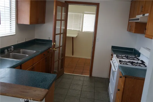 a white stove top oven sitting inside of a kitchen