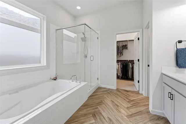 a spacious bathroom with a tub shower and sink