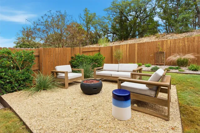 a view of a patio with chairs and plants
