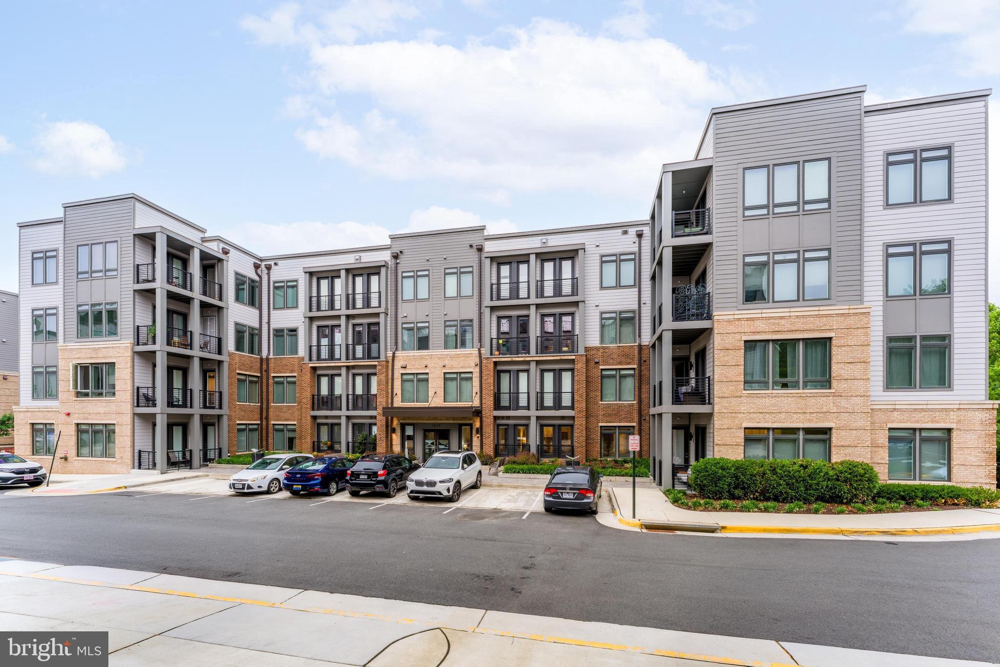 1675 Bandit Loop, Unit 105B Reston, VA 20190 - Photo 25 of 27 a city street lined with buildings and cars