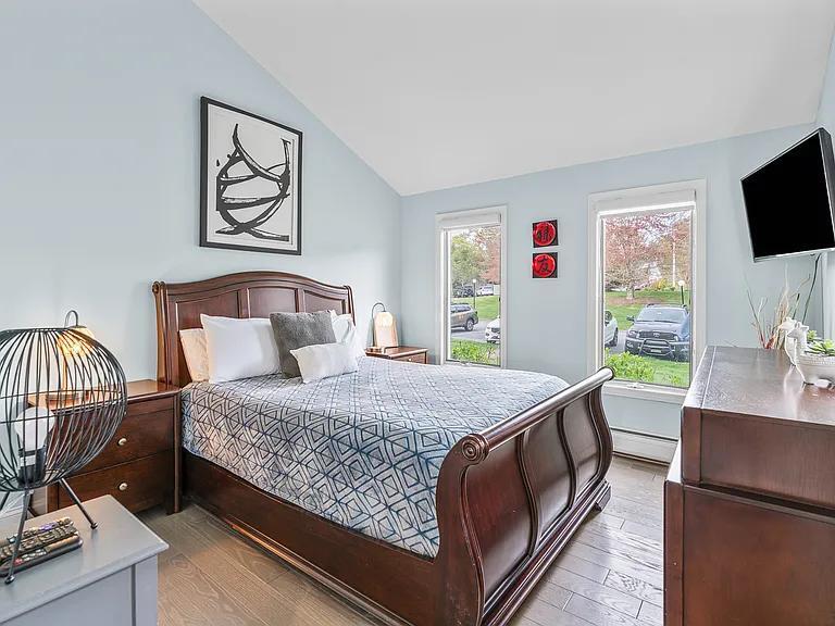15 Riverview Avenue, Unit D Mashpee, MA 02649 - Photo 17 of 33 a bedroom with a bed and a flat screen tv