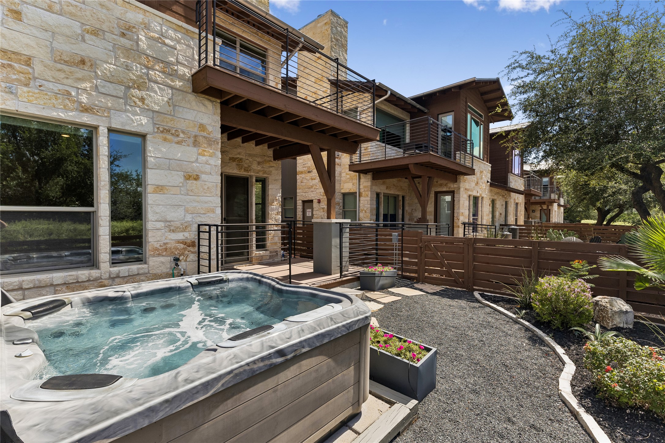 8110 Ranch Road 2222, Unit 68 Austin, TX 78730 - Photo 15 of 24 Relax in the inviting hot tub within a private outdoor sanctuary, showcasing modern architecture.