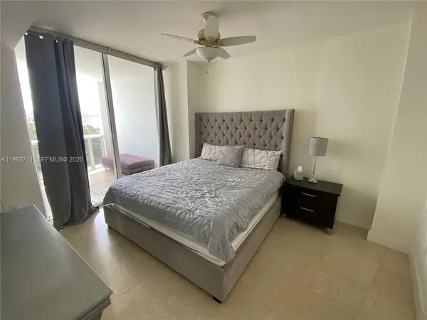 a bedroom with a bed dresser and a window