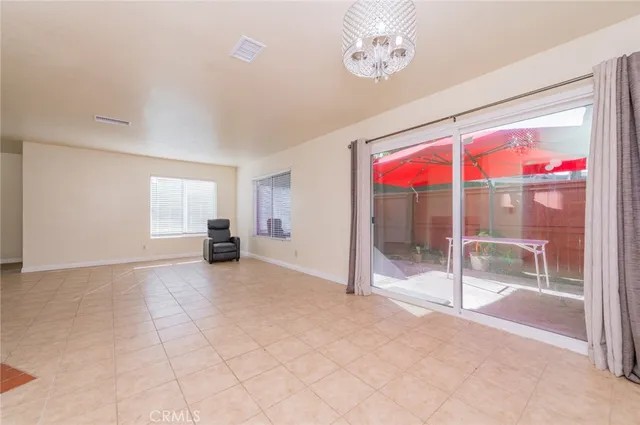 a view of hallway with a large window and chandelier