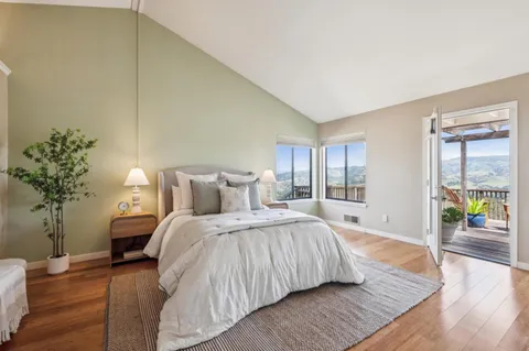 a bedroom with a bed and a potted plant