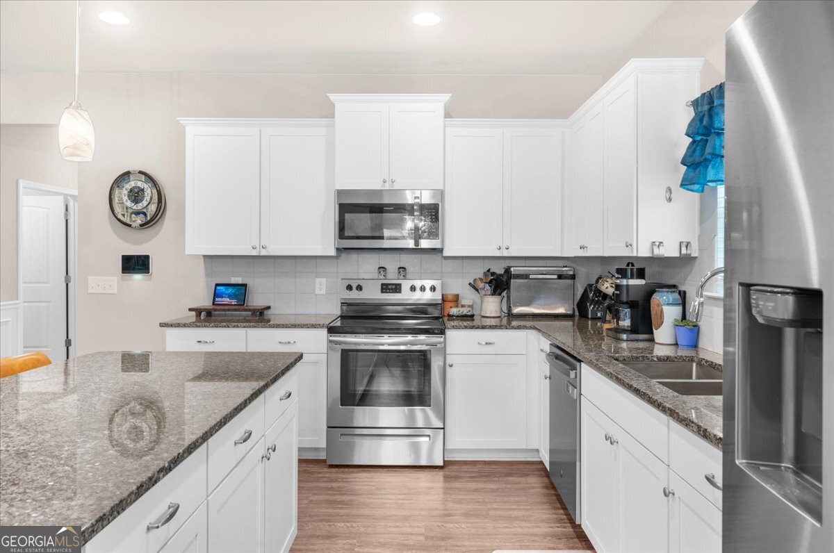 15 Gala Drive Northeast Rome, GA 30165 - Photo 24 of 60 a kitchen with granite countertop a sink a stove and cabinets