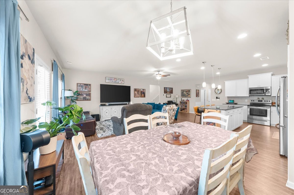 15 Gala Drive Northeast Rome, GA 30165 - Photo 27 of 60 a living room with furniture a flat screen tv and kitchen view