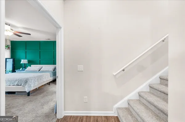 a bedroom with a bed flat screen tv and a large window