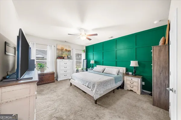 a bedroom with a bed and a flat screen tv