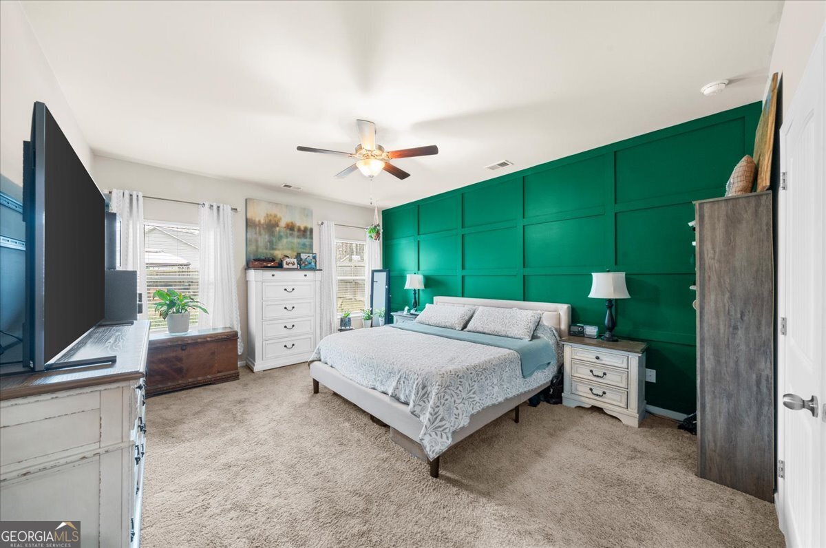 15 Gala Drive Northeast Rome, GA 30165 - Photo 36 of 60 a bedroom with a bed flat screen tv and a large window