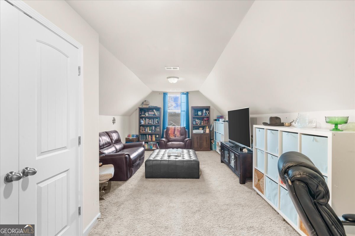 15 Gala Drive Northeast Rome, GA 30165 - Photo 44 of 60 a living room with furniture a flat screen tv and a washer dryer