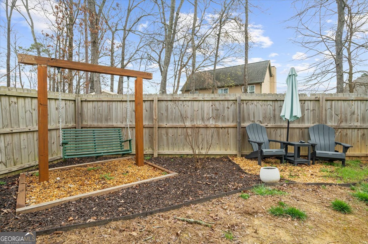 15 Gala Drive Northeast Rome, GA 30165 - Photo 49 of 60 a view of a backyard with table and chairs and wooden fence