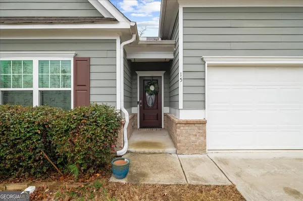 a view of a hallway with wooden floor and entryway