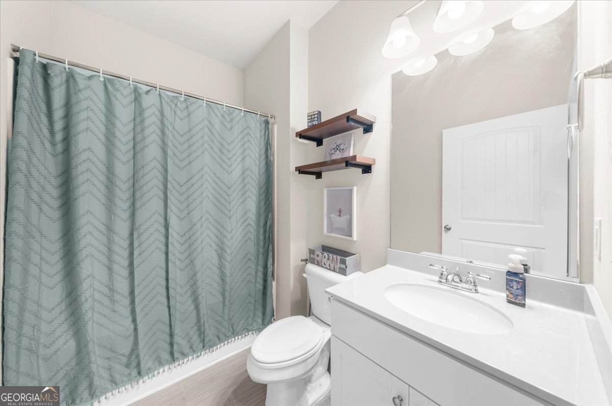 15 Gala Drive Northeast Rome, GA 30165 - Photo 9 of 60 a bathroom with a granite countertop sink and a toilet